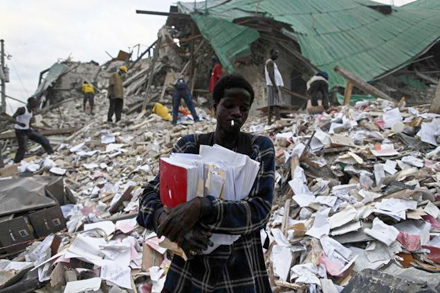 A man retrieving documents from the rubble A man retrieving documents from the rubble