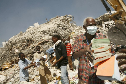 Workers painstakingly retrieve records from the ruins of the tax office; image courtesy of ICBS Workers painstakingly retrieve records from the ruins of the tax office; image courtesy of ICBS