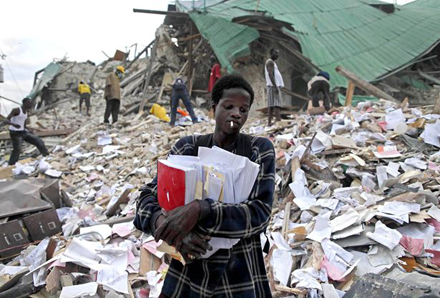 A man leaves after retrieving some documents from the rubble of a collapsed building in the aftermath of the 2010 in Port-au-Prince, Haiti. Photo: AP A man leaves after retrieving some documents from the rubble of a collapsed building in the aftermath of the 2010 in Port-au-Prince, Haiti. Photo: AP