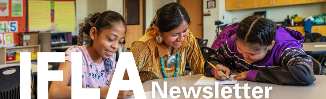 a picture of a group of girls writing on a desk