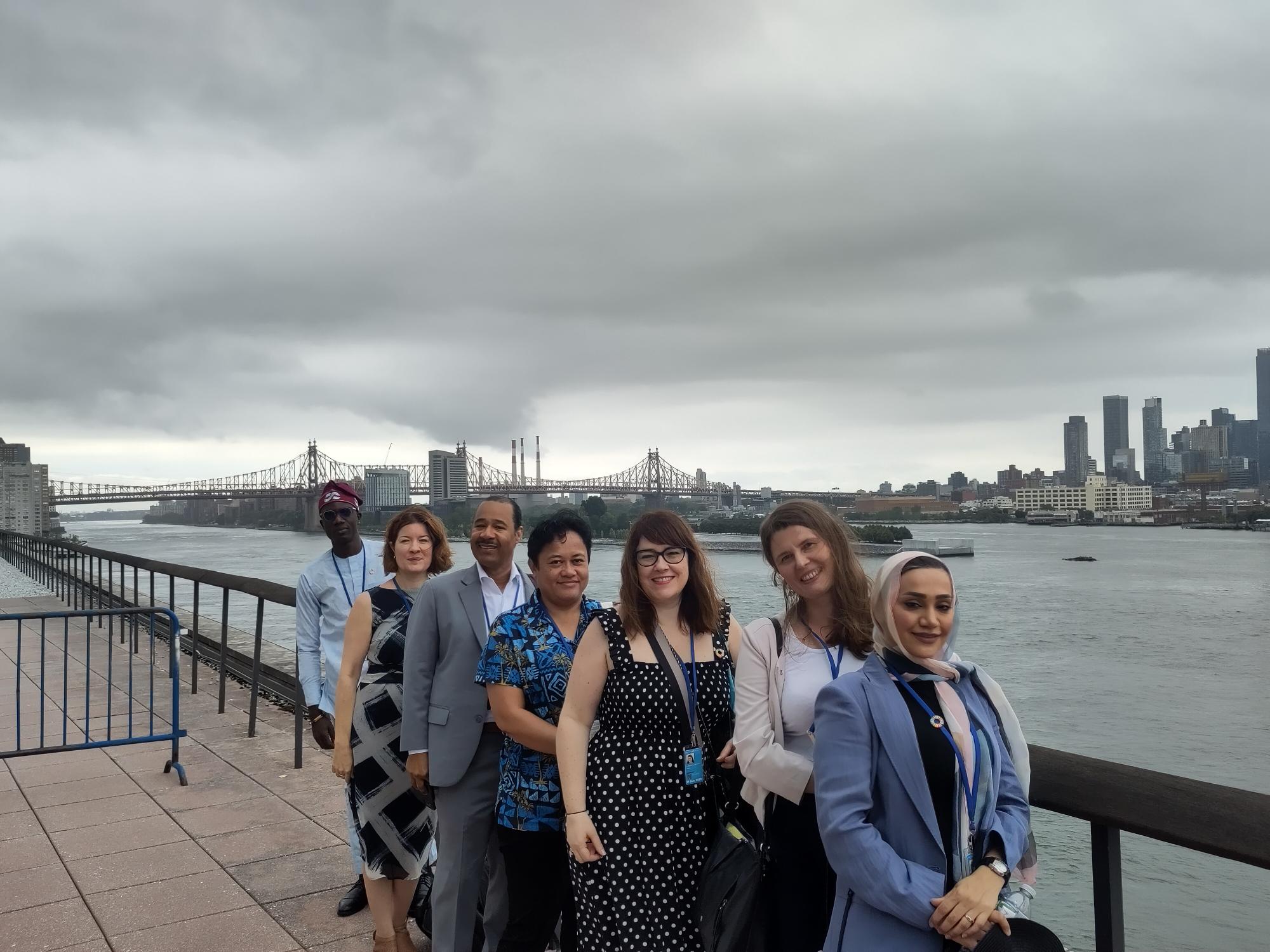 HLPF Group Shot Wk1 Group of IFLA representatives next to the East River in New York, with a cityscape further on