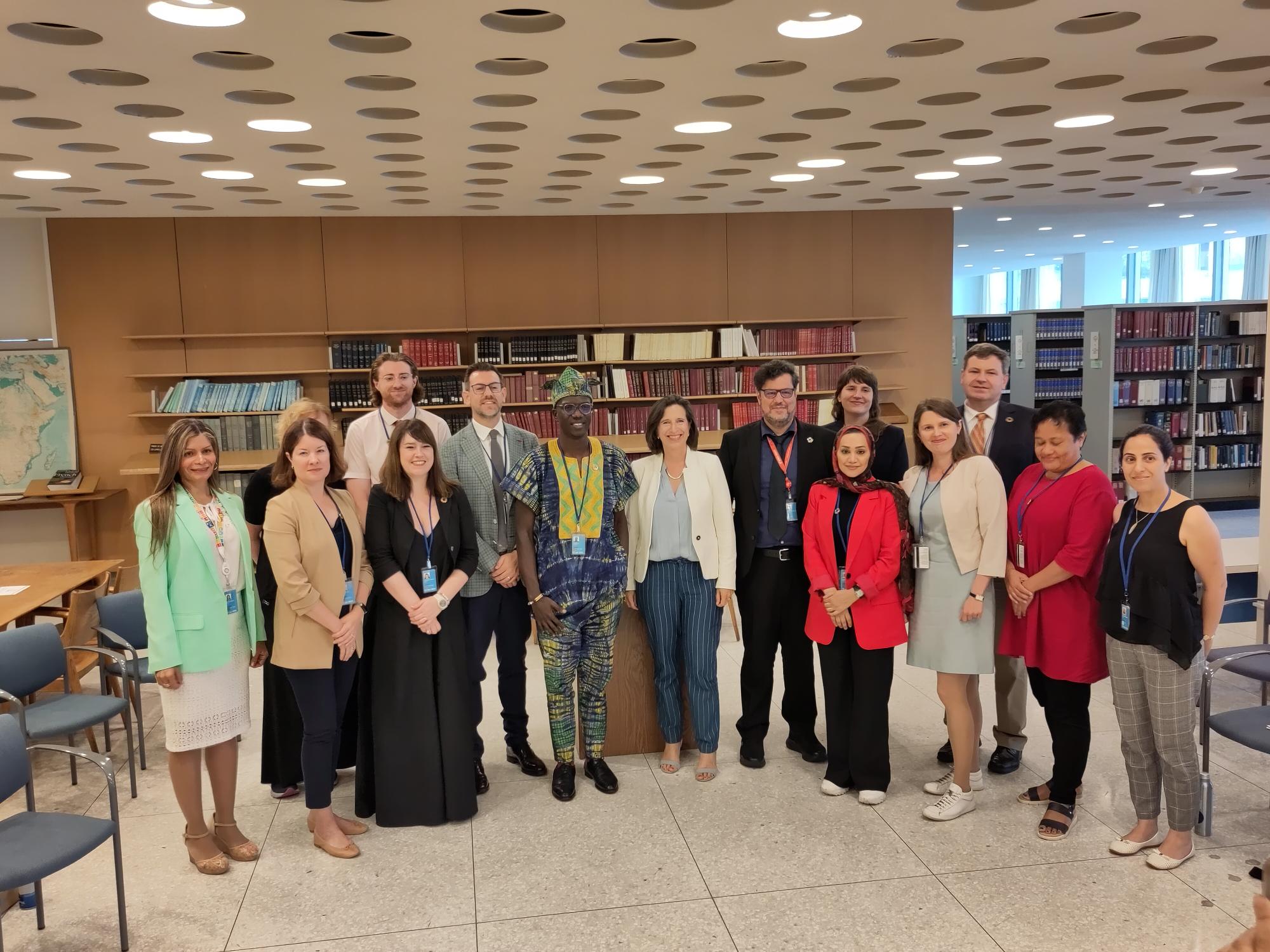 HLPF side evet shot Group of people posing for a photo in a library