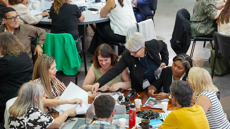 Group of people working at a table, with the photo taken from above