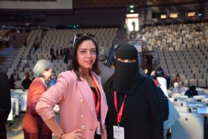 IFLA QIMAM recipients at WLIC 2025 An image of two people standing and posing in an auditorium
