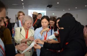 An image of a group of people exchanging documents