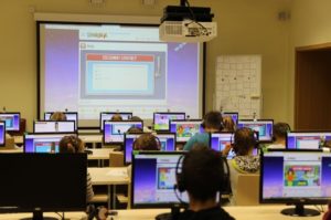 A group of people in a room with computers