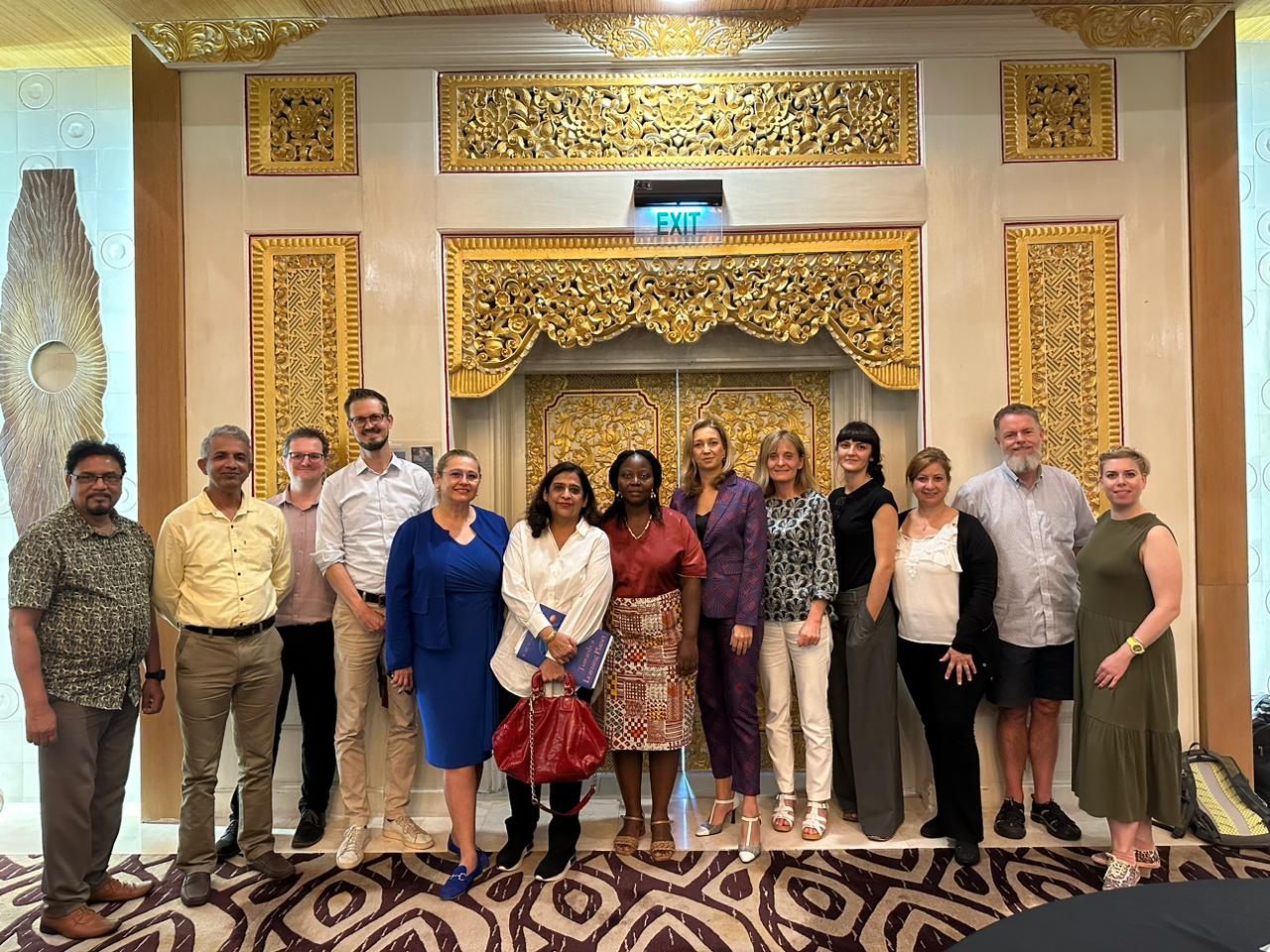 WCAE Photo Group of participants at the World Assembly on Adult Education - people from different parts of the world in front of a decorated Balinese door