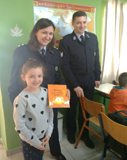 Members of the Mobile Police Unit delivering books to schools