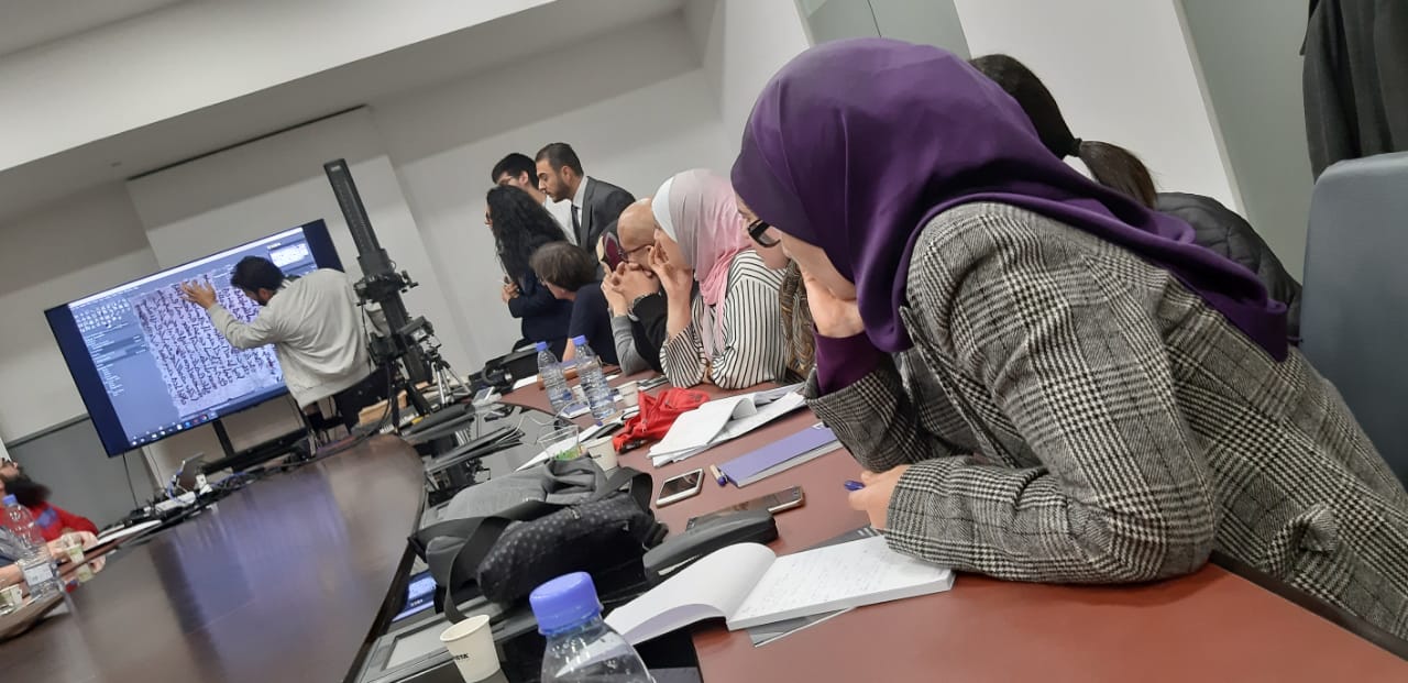 Attendees watch a demonstration during the workshop on methods for scientific examination of library objects.
